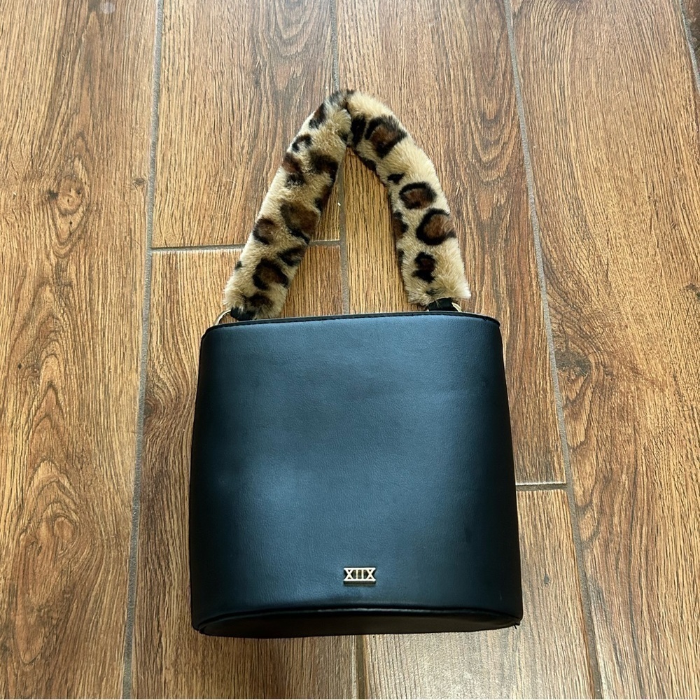 Faux leather bucket bag with faux fur handle strap